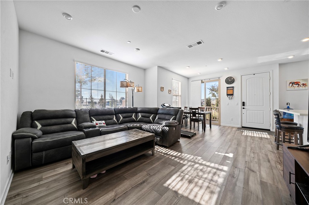 981 West Clover Avenue Rialto, CA 92376 - Photo 3 of 11 a living room with furniture a wooden floor and next to a window