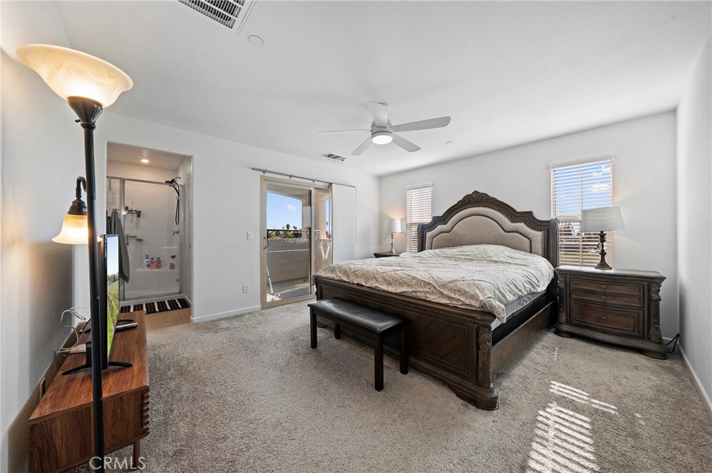 981 West Clover Avenue Rialto, CA 92376 - Photo 4 of 11 a bedroom with a bed and a chandelier