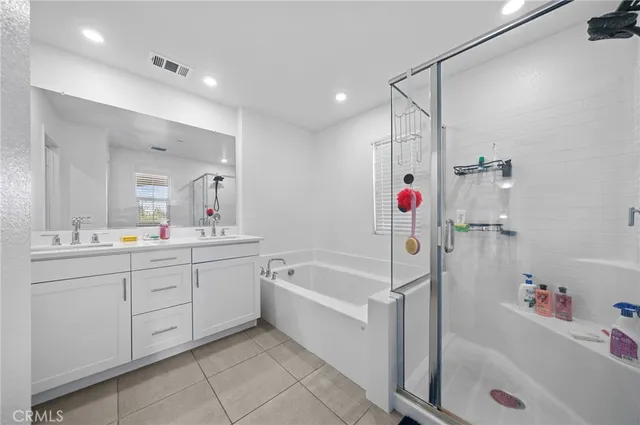 a bathroom with a tub a sink and a mirror