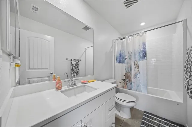 a bathroom with a sink toilet tub and shower