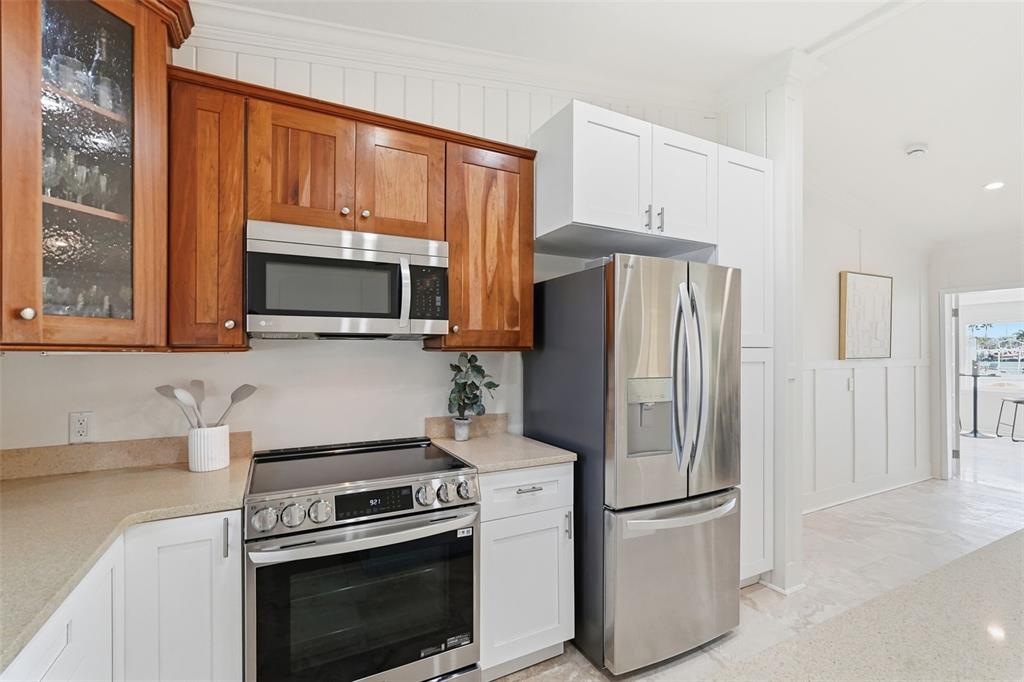 15302 Harbor Drive Madeira Beach, FL 33708 - Photo 17 of 47 a kitchen with stainless steel appliances a refrigerator stove and microwave