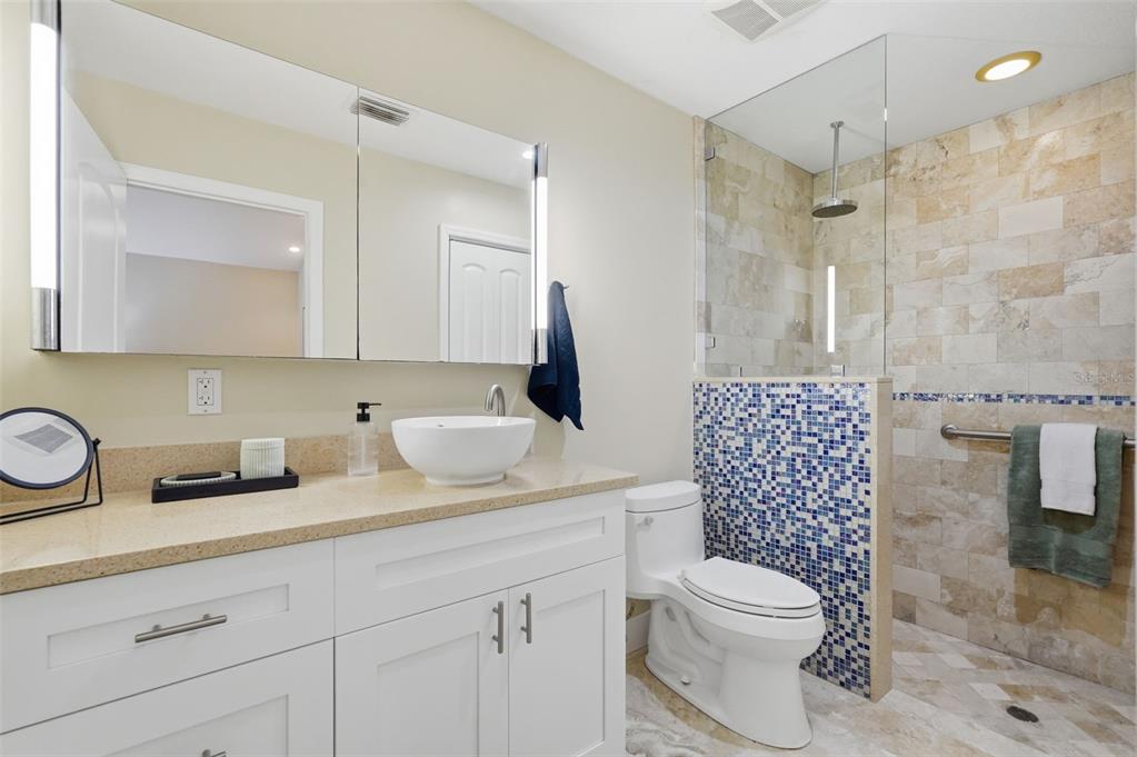 15302 Harbor Drive Madeira Beach, FL 33708 - Photo 24 of 47 a bathroom with a sink a toilet and shower
