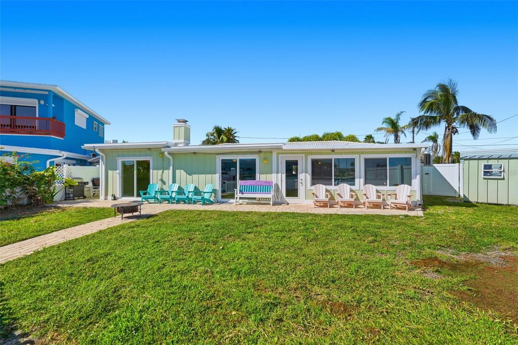 15302 Harbor Drive Madeira Beach, FL 33708 - Photo 35 of 47 a front view of a house with swimming pool having outdoor seating