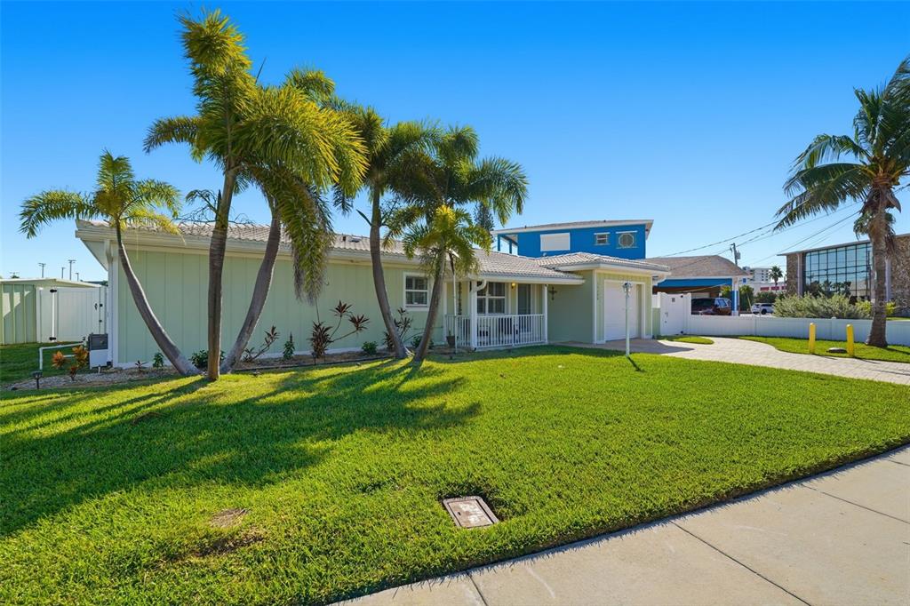 15302 Harbor Drive Madeira Beach, FL 33708 - Photo 4 of 47 a house with a swimming pool in front of it