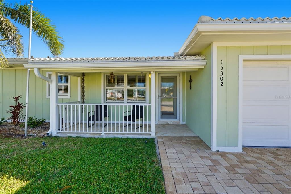 15302 Harbor Drive Madeira Beach, FL 33708 - Photo 5 of 47 a view of a house with a small yard and a porch