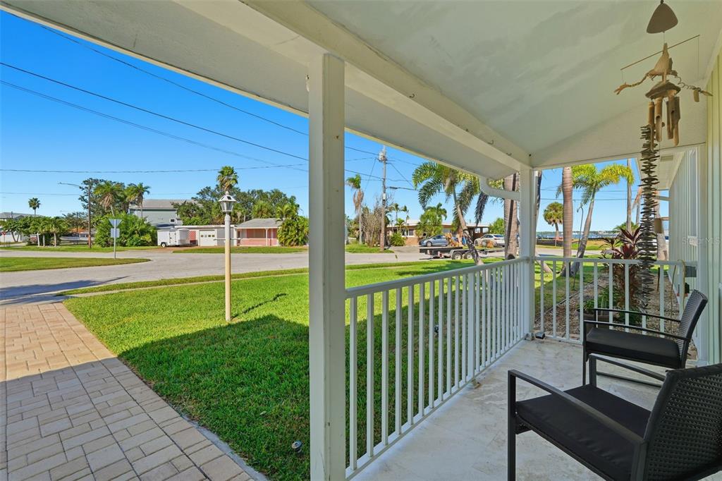 15302 Harbor Drive Madeira Beach, FL 33708 - Photo 6 of 47 a view of a porch with wooden floor and fence