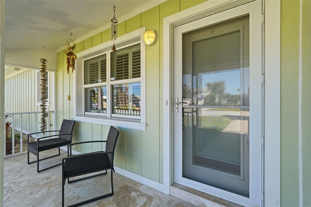 15302 Harbor Drive Madeira Beach, FL 33708 - Photo 7 of 47 a view of a hallway with a dining room and glass door