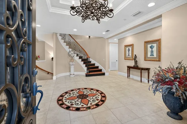 a bedroom with a bed a large window with table and chair