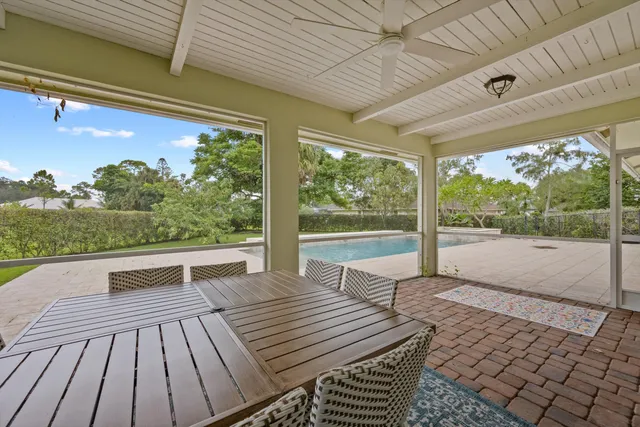 a view of house with swimming pool outdoor seating