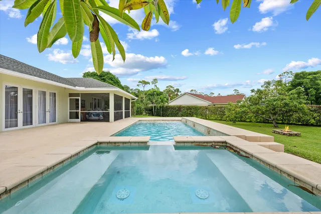 a view of a swimming pool and trees in the background