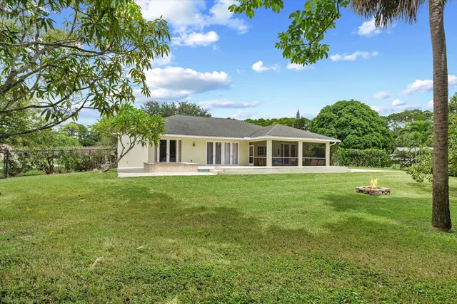 a kitchen with stainless steel appliances kitchen island granite countertop a sink and cabinets