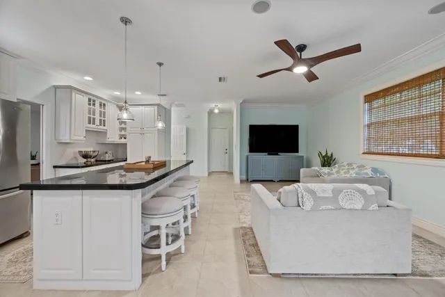 a kitchen with granite countertop stainless steel appliances a stove sink microwave and cabinets