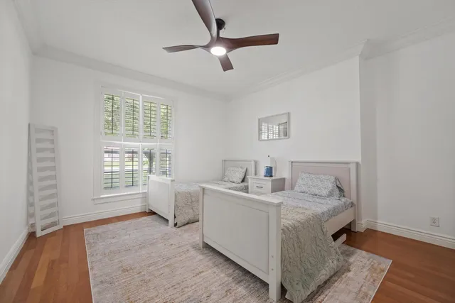 a bedroom with a bed and a large window