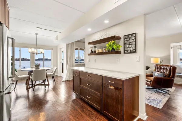 a kitchen with stainless steel appliances granite countertop a table chairs and a couch
