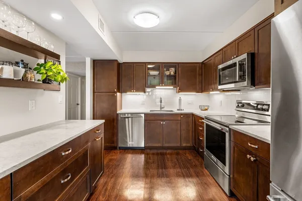 a kitchen with a sink stove and microwave
