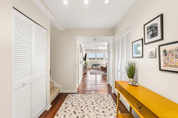 a hallway with a dining table and chairs