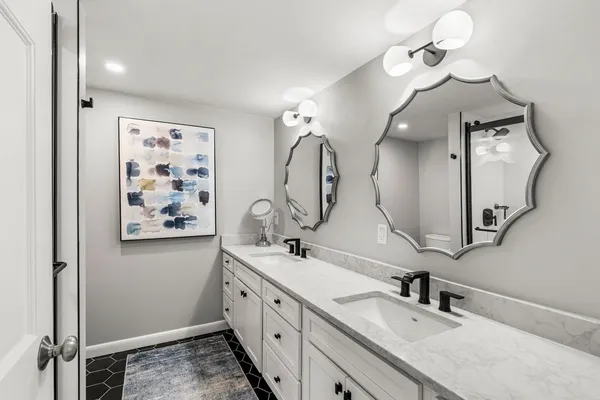 a bathroom with a double vanity sink and a mirror