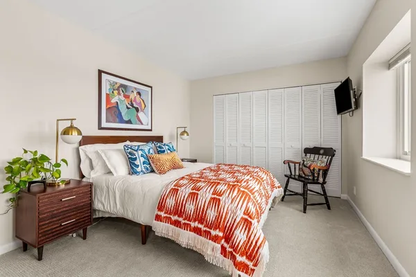 a bedroom with a bed and a chair