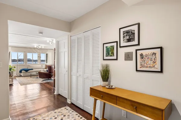 a living room with furniture and a view of kitchen