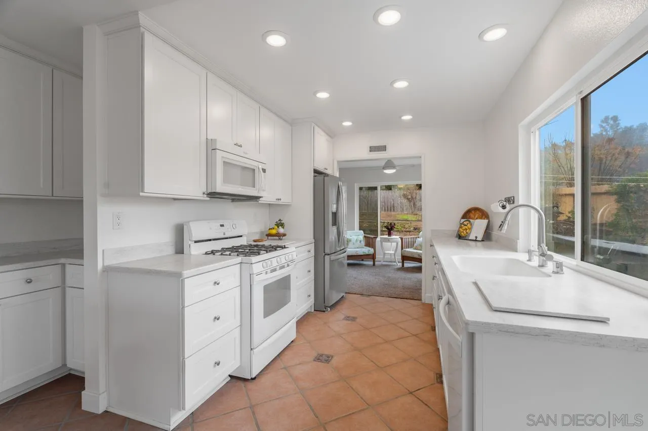 801 Ladysmith Drive El Cajon, CA 92020 - Photo 8 of 38 a kitchen that has a lot of cabinets in it and wooden floors