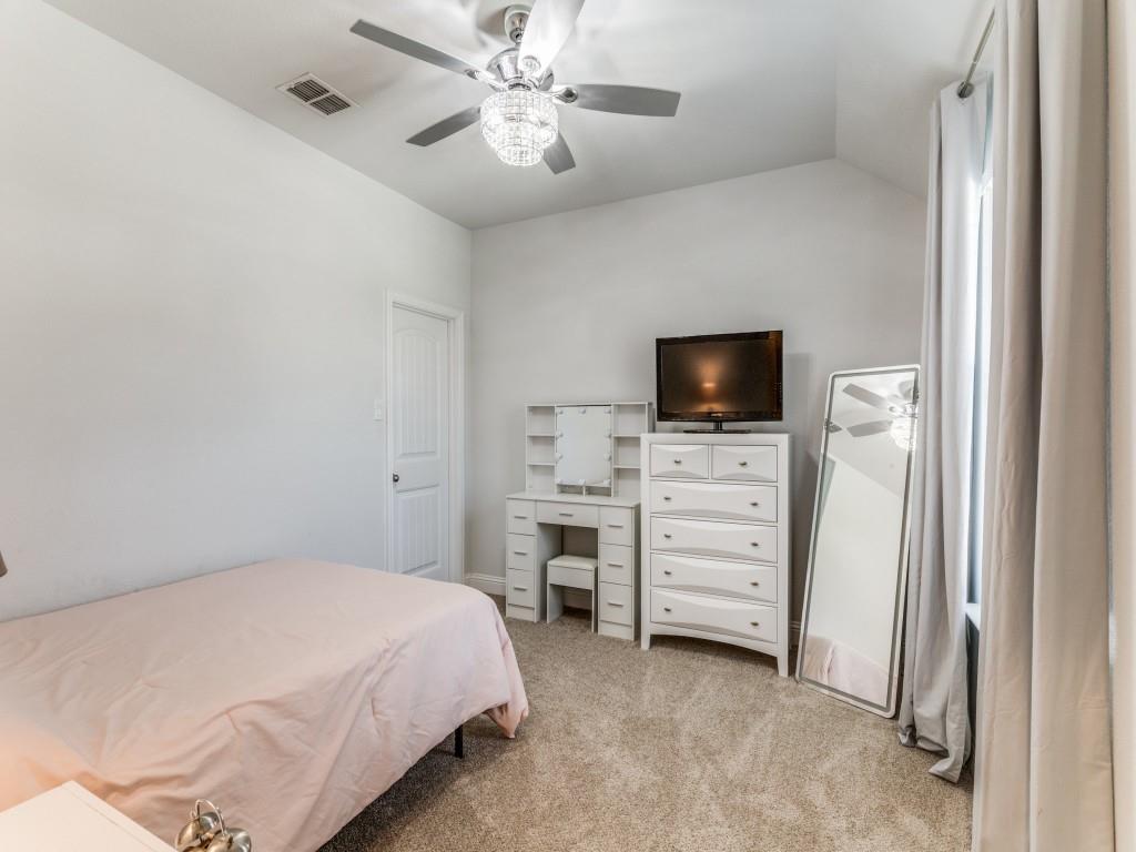 5944 Bursey Road Watauga, TX 76148 - Photo 20 of 25 a bedroom with a large bed and a flat tv screen on dresser