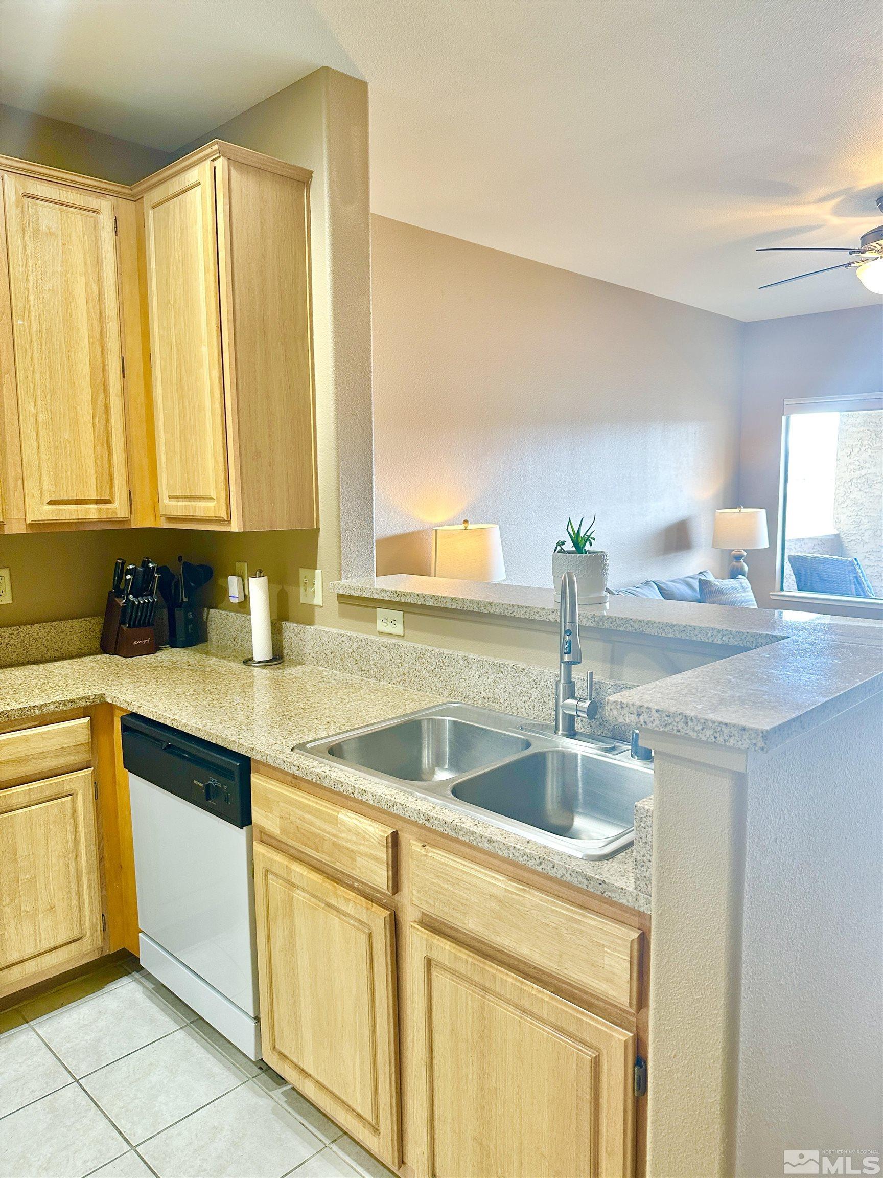 900 S Meadows, Unit 5122 Reno, NV 89521 - Photo 22 of 38 a kitchen with granite countertop a sink and white cabinets
