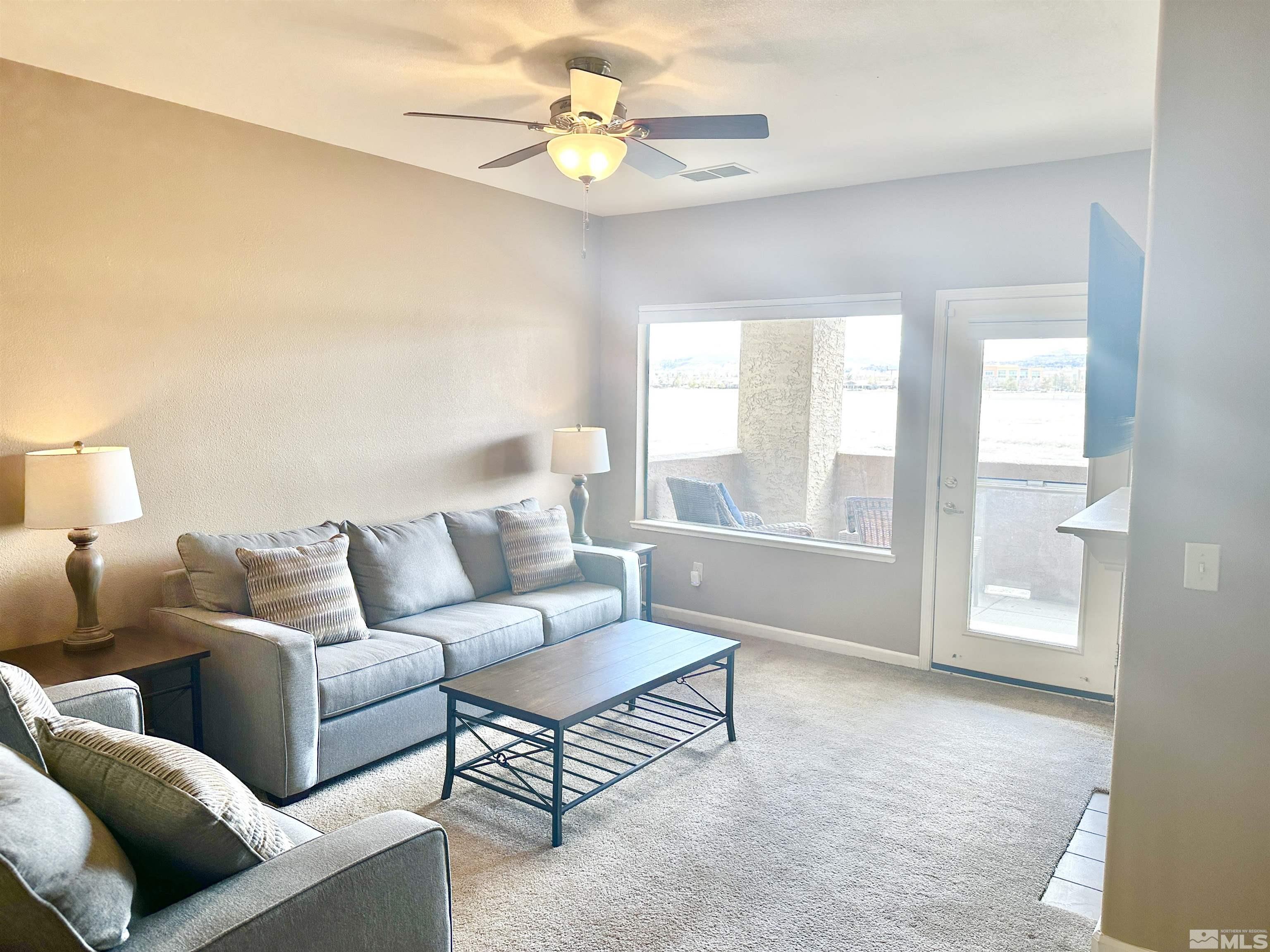 900 S Meadows, Unit 5122 Reno, NV 89521 - Photo 24 of 38 a living room with furniture and a large window