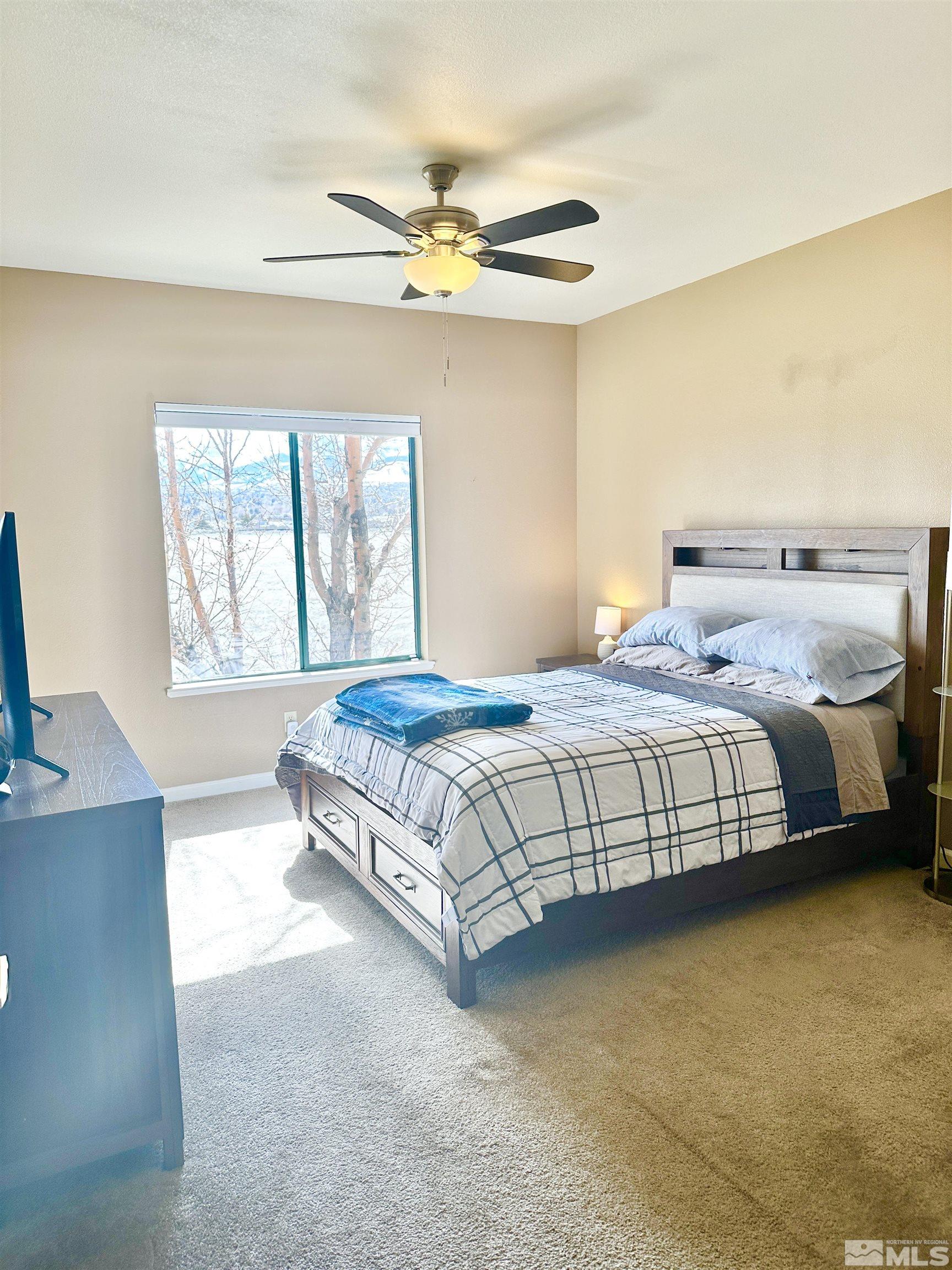 900 S Meadows, Unit 5122 Reno, NV 89521 - Photo 26 of 38 a bedroom with a bed table and window