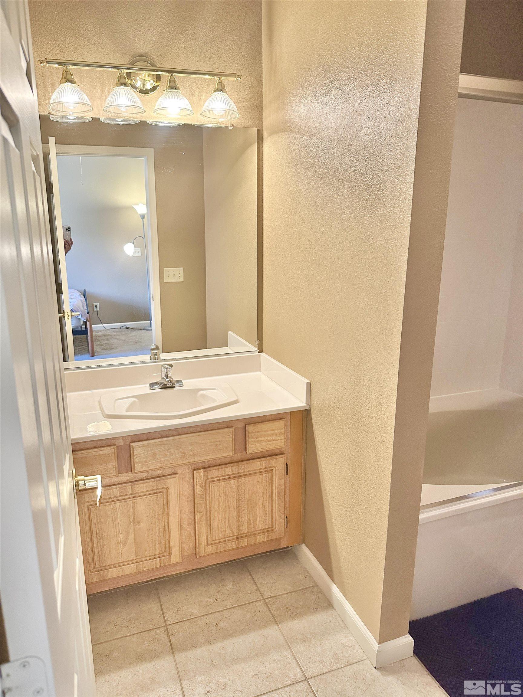 900 S Meadows, Unit 5122 Reno, NV 89521 - Photo 33 of 38 a bathroom with a sink and a mirror