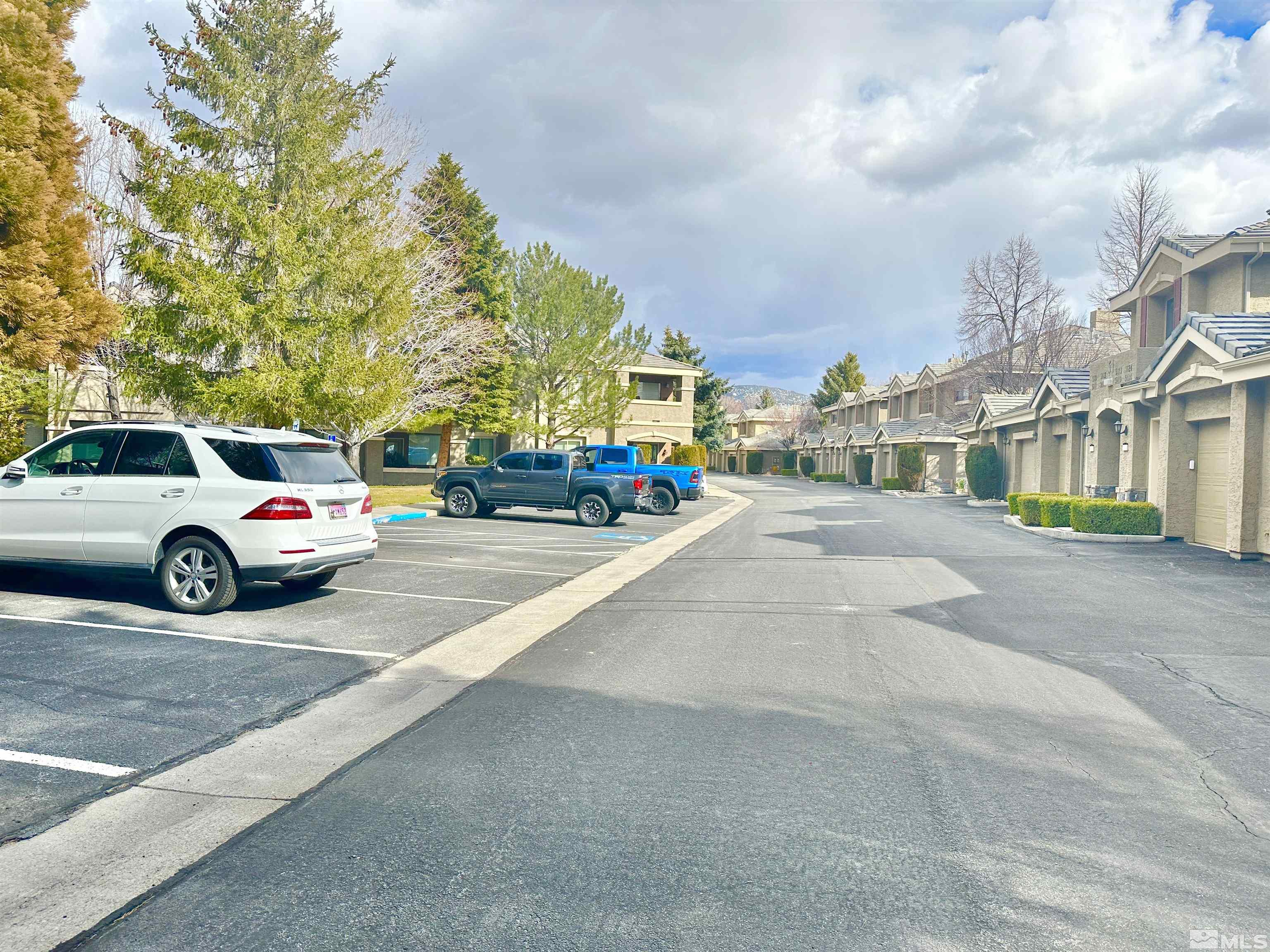 900 S Meadows, Unit 5122 Reno, NV 89521 - Photo 37 of 38 a view of a city street with a cars parked on the roadside
