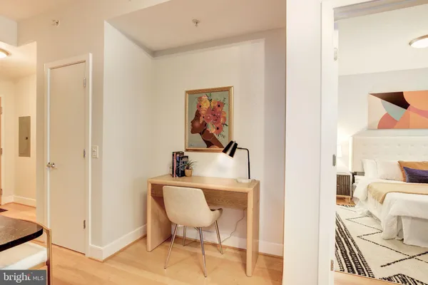 a view of a bedroom with a table and chairs