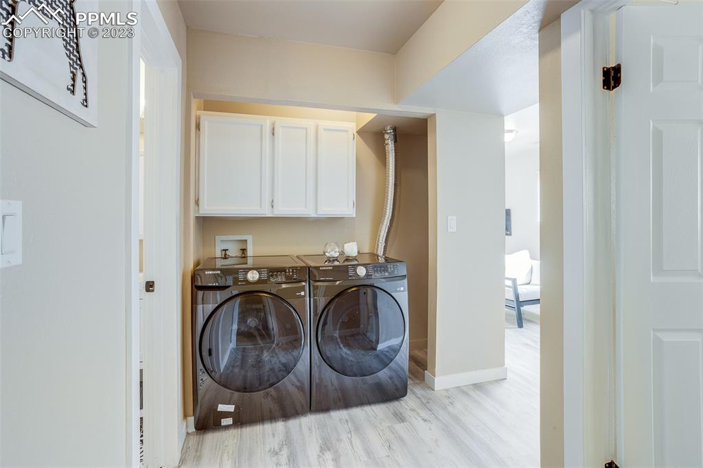 2139 Preuss Road, Unit C Colorado Springs, CO 80910 - Photo 12 of 14 a utility room with wooden floor washer and dryer