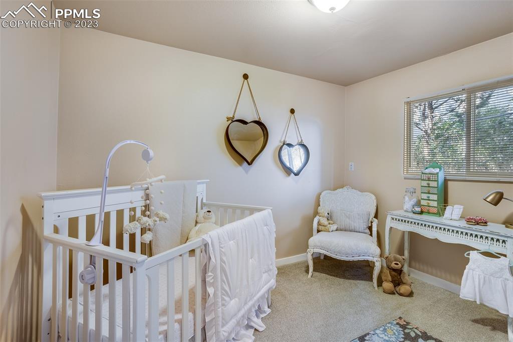 2139 Preuss Road, Unit C Colorado Springs, CO 80910 - Photo 10 of 14 a bedroom with furniture and windows