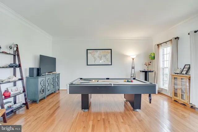 a view of a workspace with furniture and wooden floor