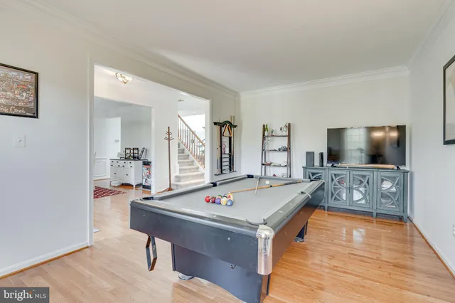 a living room with table tennis and a flat screen tv