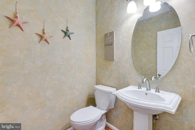 a spacious bedroom with a bed and a chandelier