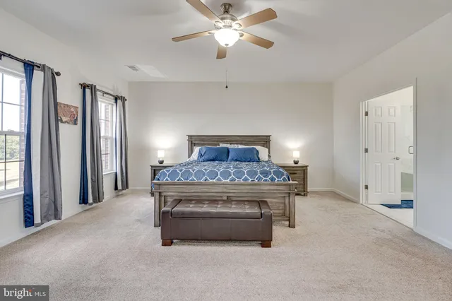 a view of walk in closet with clothes