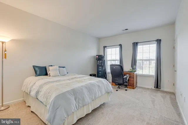 a view of a house with a big yard and large trees
