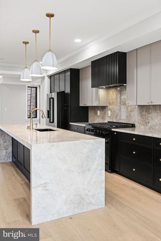 a kitchen with stainless steel appliances granite countertop sink stove top oven and cabinets