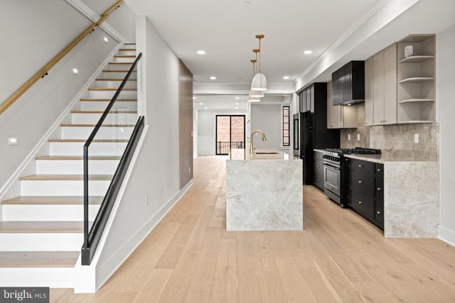 a view of kitchen with sink microwave and stove