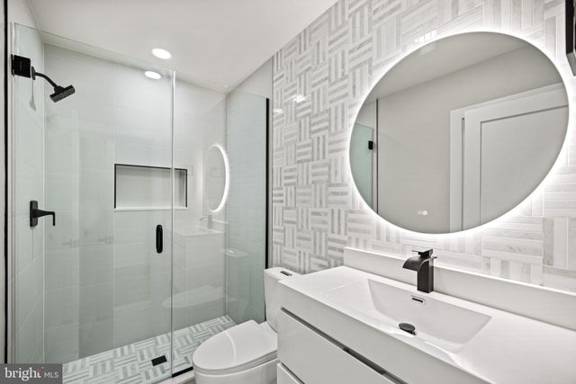 a white toilet sitting next to a bath tub