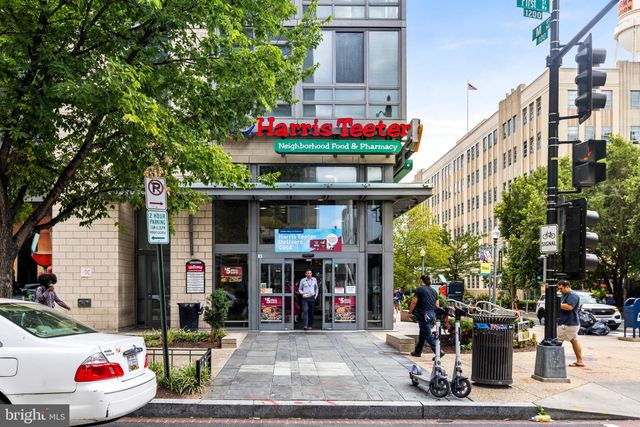 a store with outdoor seating and a potted plant