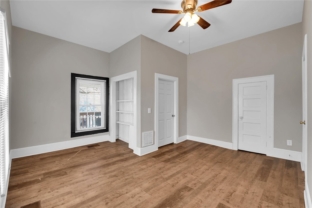 309 Hill Street Easley, SC 29640 - Photo 21 of 25 This versatile room features warm flooring and ample natural light, creating an inviting atmosphere for various uses.