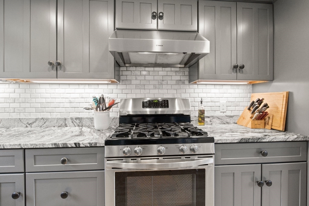 2045 Main Street Barnstable, MA 02648 - Photo 12 of 41 a kitchen with granite countertop stainless steel appliances stove top oven and cabinets