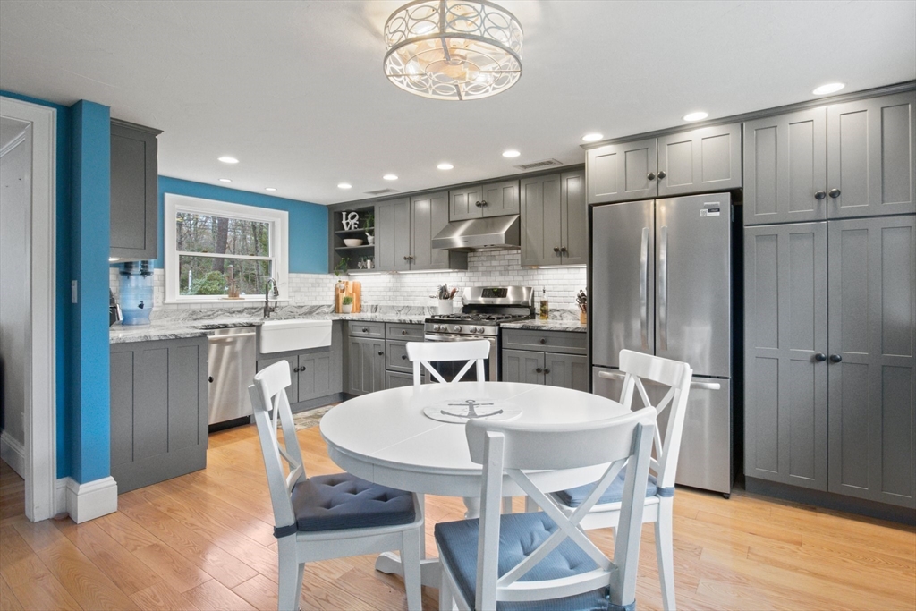 2045 Main Street Barnstable, MA 02648 - Photo 14 of 41 a kitchen with a dining table chairs and refrigerator