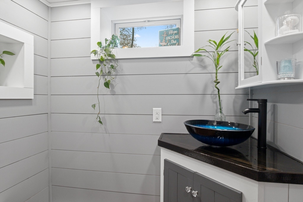 2045 Main Street Barnstable, MA 02648 - Photo 16 of 41 a bathroom with a potted plant and a potted plant