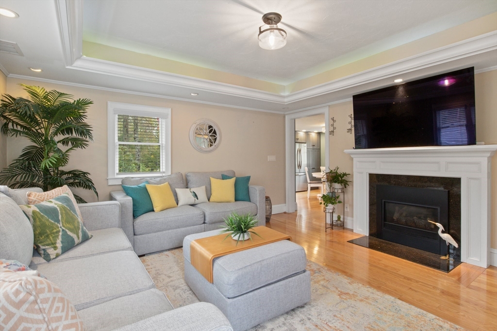 2045 Main Street Barnstable, MA 02648 - Photo 2 of 41 a living room with furniture a flat screen tv and a fireplace