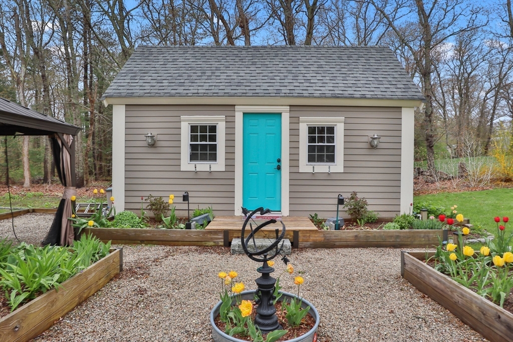 2045 Main Street Barnstable, MA 02648 - Photo 26 of 41 a front view of a house with a yard and a garden