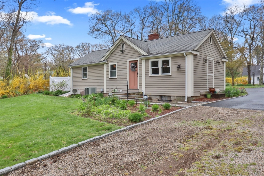 2045 Main Street Barnstable, MA 02648 - Photo 28 of 41 a front view of a house with a yard and garage