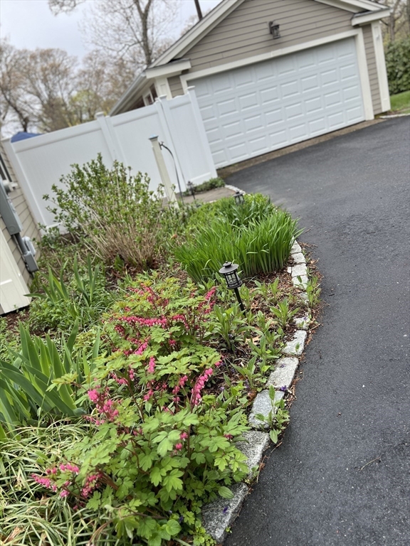 2045 Main Street Barnstable, MA 02648 - Photo 32 of 41 a backyard of a house with a yard and flowers